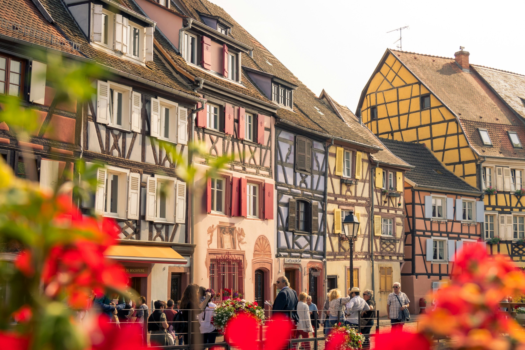 Traditional Alsatian pottery sign and colourful timber-framed houses